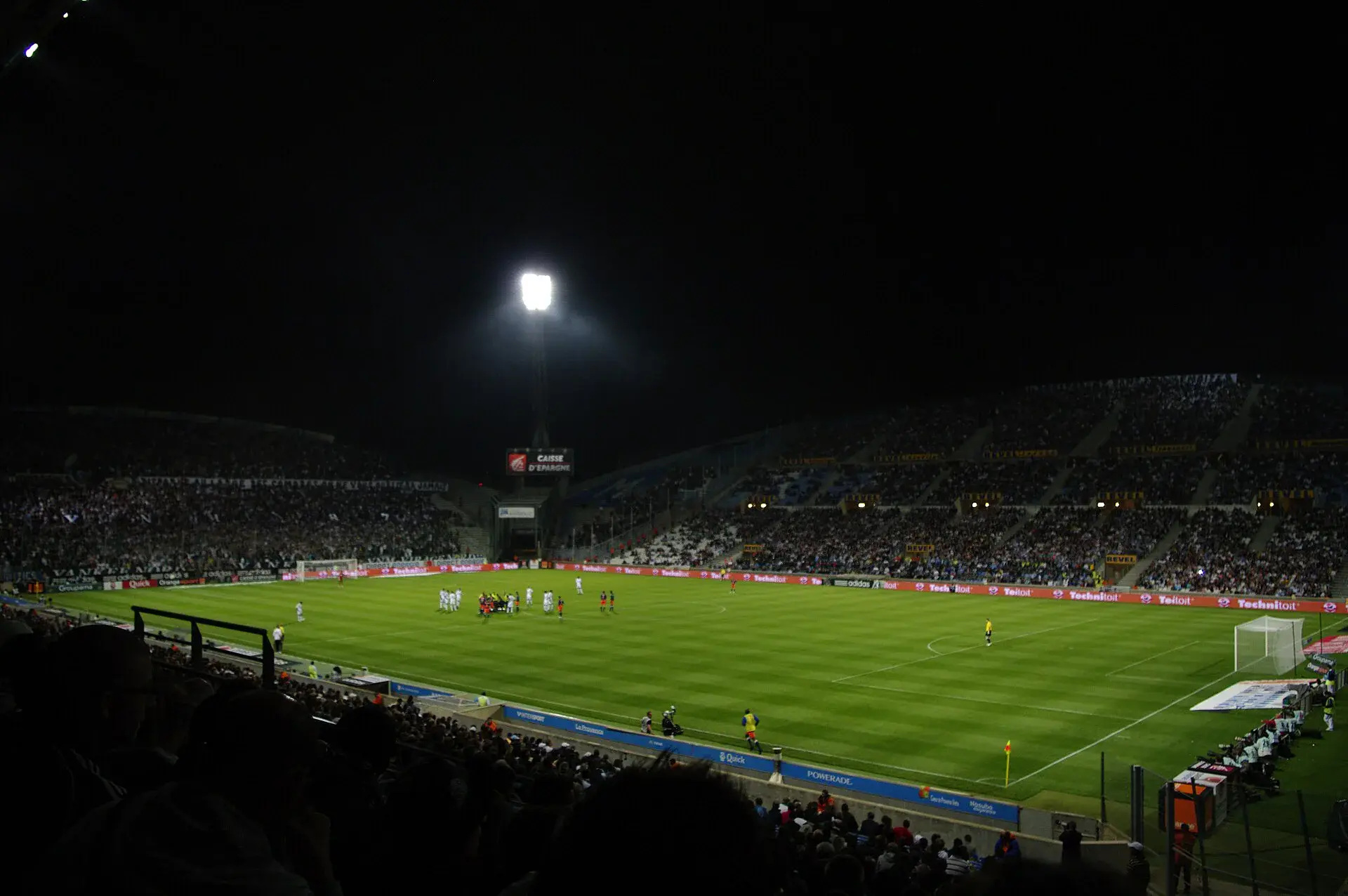 Tribunes et pelouse du stade Vélodrome éclairées de nuit pendant un match de l'OM